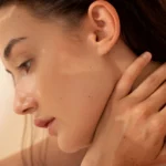 Close-up of a woman with glowing, flawless skin touching her neck — Get Red-Carpet Skin: Celebrity-Style Treatments in Hyderabad.