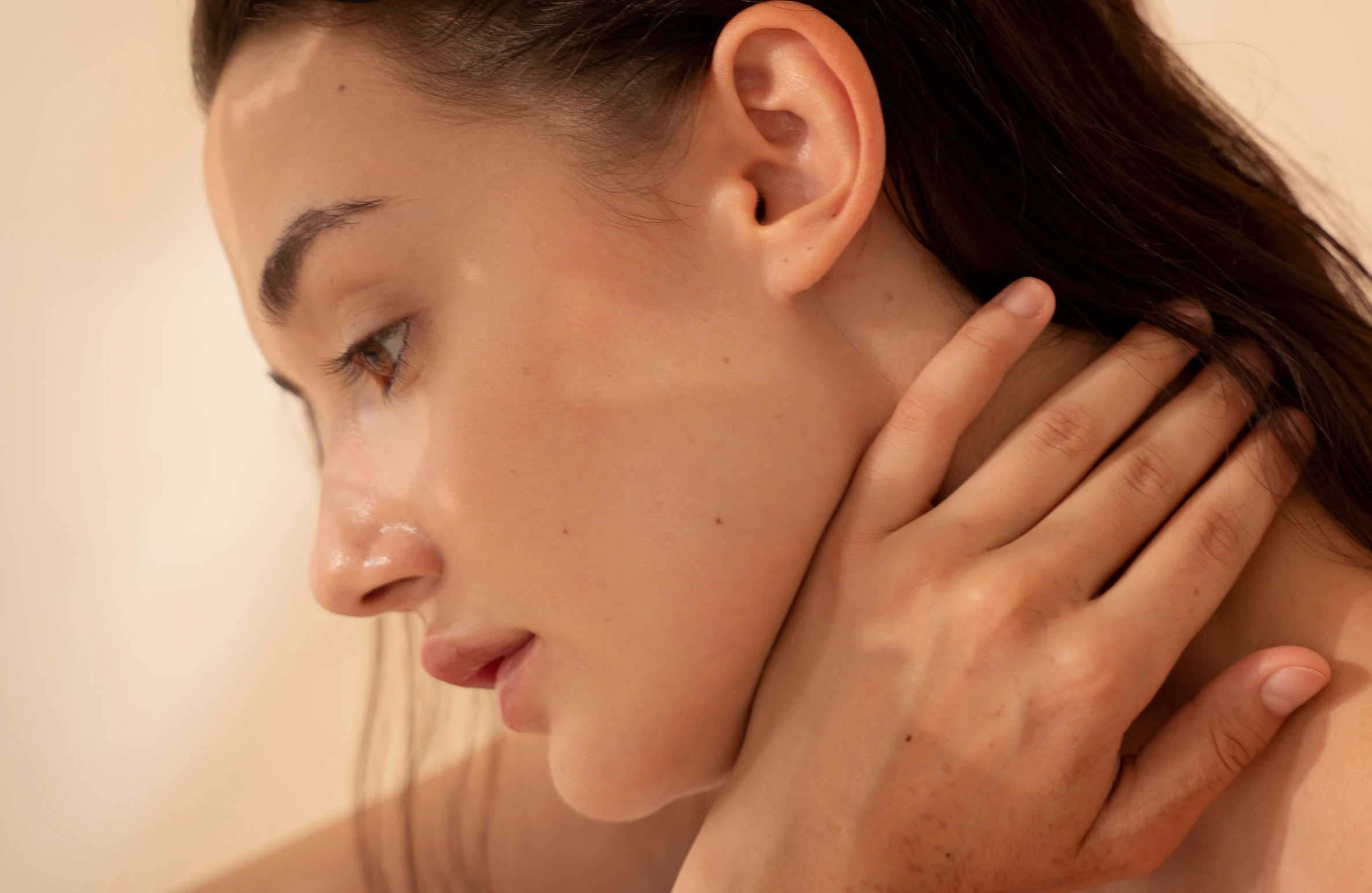 Close-up of a woman with glowing, flawless skin touching her neck — Get Red-Carpet Skin: Celebrity-Style Treatments in Hyderabad.