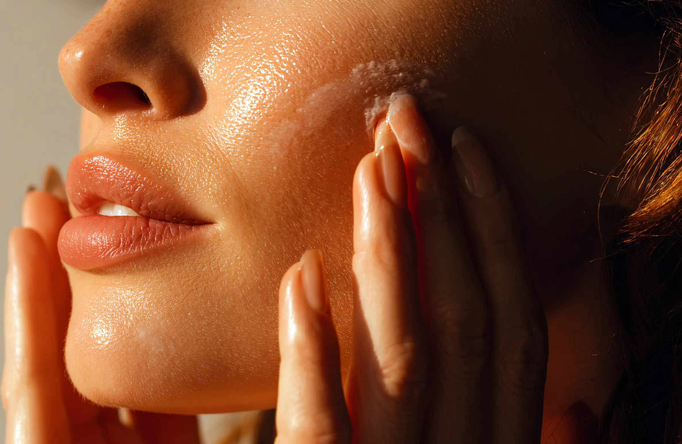 Woman gently applying moisturizer to her face, illustrating dermatologist-approved skincare tips for dry Hyderabad winters.